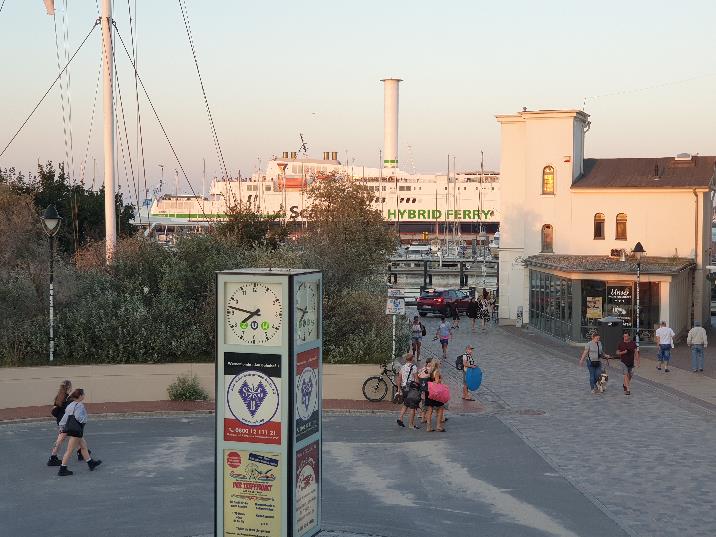 A group of people walking in a city

Description automatically generated