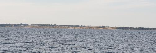 A large body of water with land in the background

Description automatically generated