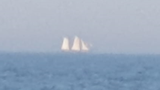 A sailboat in the ocean

Description automatically generated